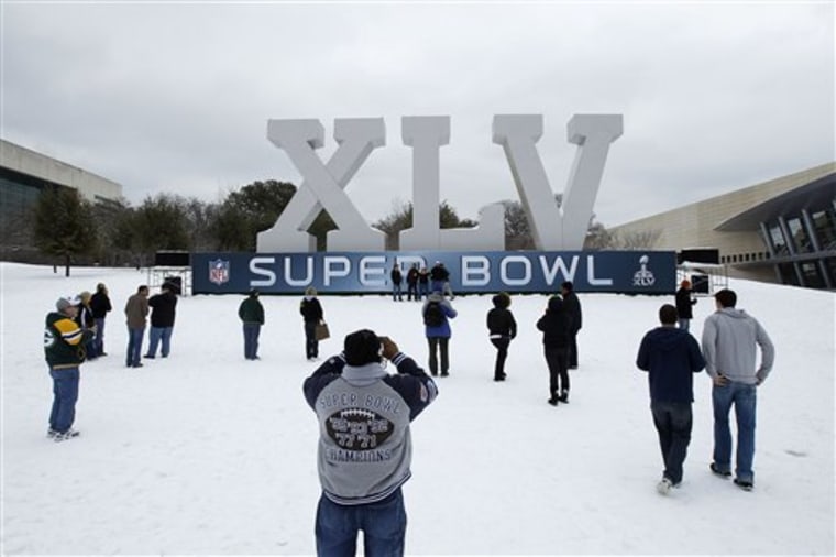 Fans near the NFL Super Bowl Experience during a winter storm on Friday in Dallas. 